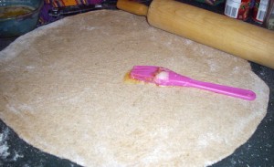 Roll the dough as thinly as possible and spread with garlic butter.