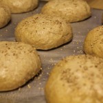 Sprinkle buns with sesame seeds