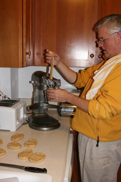 Putting the dough through the pasta maker.